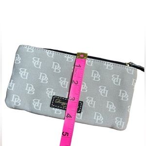 Dooney and Bourke wristlet, preloved in good condition canvas red interior